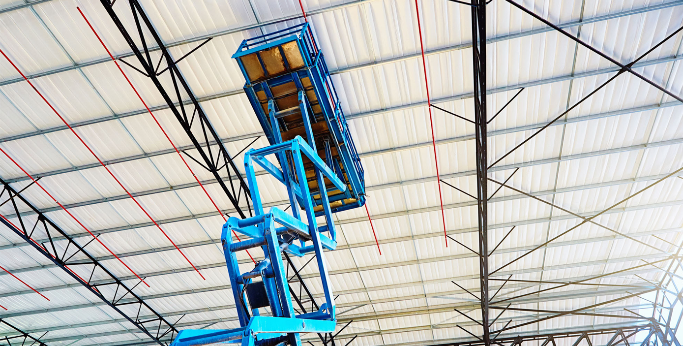 Image of a blue scissor lift in the extended position.