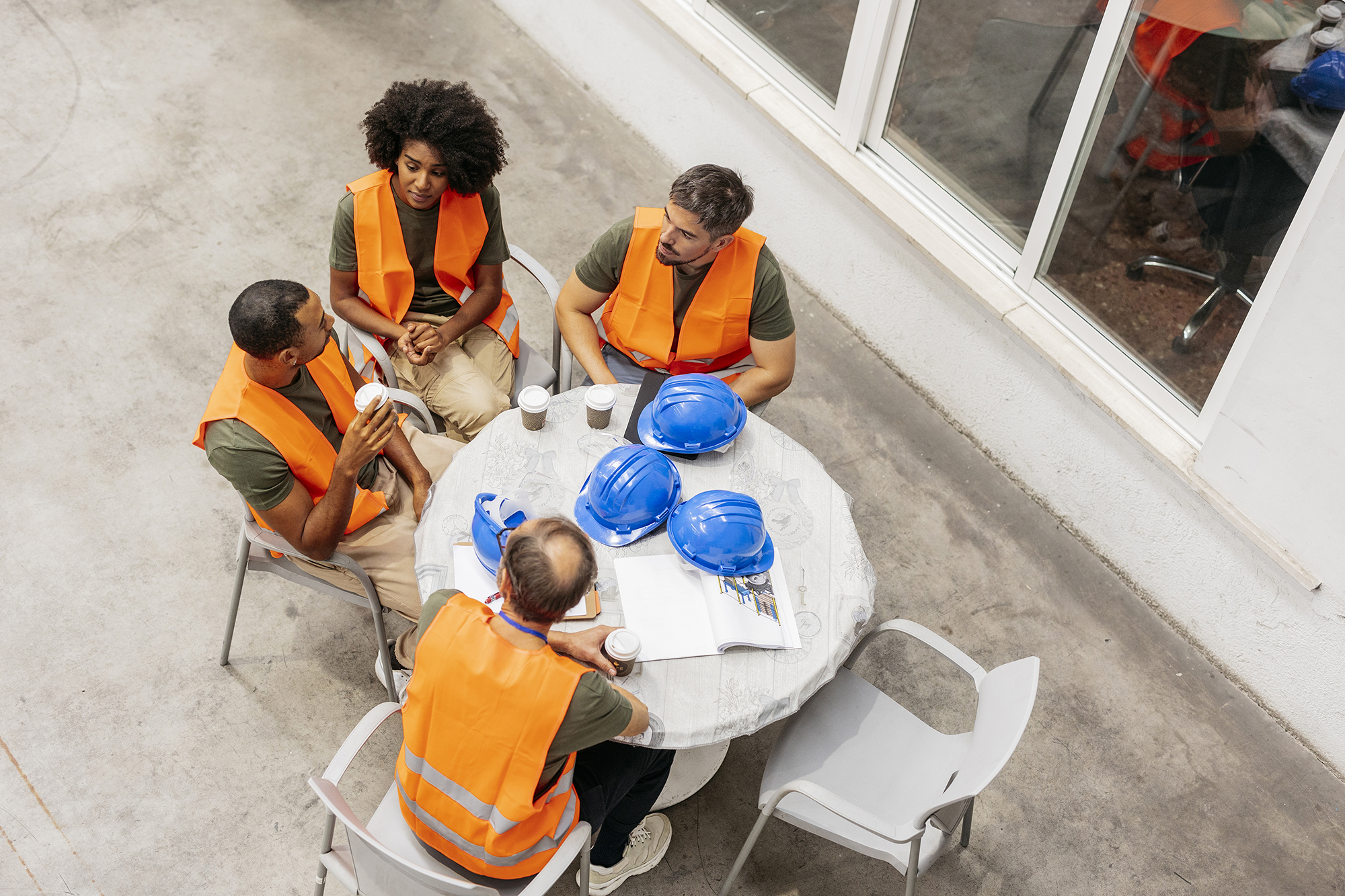 Contractors having a safety meeting to ensure compliance